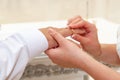 Hands of the bride and groom, close-up. The bride puts the wedding ring on the groom`s finger during the wedding ceremony Royalty Free Stock Photo