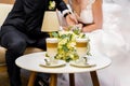 Hands of the bride and groom for a cup of coffee. Wedding bouquet on the table. Royalty Free Stock Photo
