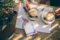 Hands of the bride and groom for a cup of coffee. Wedding bouquet on the table. Royalty Free Stock Photo