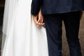 Hands of bride and groom. New young couple holding hands after their wedding. Young married couple holding hands, ceremony wedding