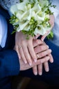hands of bride and groom with rings. bride and groom . wedding bouquet table. bride and groom hold each other's hands. Royalty Free Stock Photo