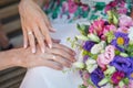 Hands of bride and groom with rings and wedding bouquet Royalty Free Stock Photo