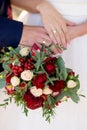 Hands of bride and groom with rings on wedding bouquet. Marriage concept Royalty Free Stock Photo