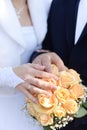 Hands of bride and groom with rings on wedding bouquet. Marriage concept Royalty Free Stock Photo