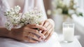 Hands of the bride with wedding nail design