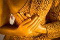 Hands of buddha statue touching the heart on chest level