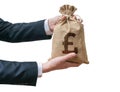 Hands of business man holds bag full of money with British pounds Royalty Free Stock Photo