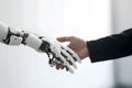 Hands of a business man and a robot in a handshake. Conceptual template of friendship between artificial and real person Royalty Free Stock Photo