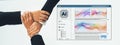 Hands of business professionals collaborating around a computer screen displaying colorful wave patterns and AI software Royalty Free Stock Photo