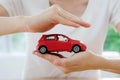 Hands of a business woman holding a red toy car Royalty Free Stock Photo