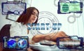 Hands of a business woman using a laptop with a smart phone and a futuristic holographic screen in currency exchange rate charts Royalty Free Stock Photo