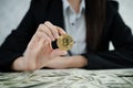 Hands of business women holding Bitcoin and money dollar pile on Royalty Free Stock Photo