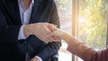 The hands of business women and men in suits Hand in hand Indicates business success and agreements Holding hands shows sincerity