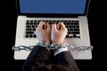 Hands of businessman addicted to work bond with chain to computer laptop in workaholic Royalty Free Stock Photo