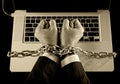 Hands of businessman addicted to work bond with chain to computer laptop in workaholic Royalty Free Stock Photo