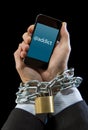 Hands of businessman addicted to work chain locked in mobile phone addiction