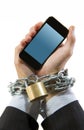 Hands of businessman addicted to work chain locked in mobile phone addiction