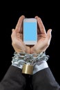 Hands of businessman addicted to work locked and enchained in mobile phone addiction