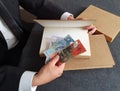 hands of a businessman with Australian money and books on the table Royalty Free Stock Photo