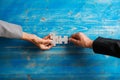 Hands of businessman and businesswoman matching two blank puzzle pieces Royalty Free Stock Photo