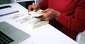 Hands of businessman counting and distributing money