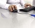 Hands of businessman holding computer mouse and keyboard in office. Male office worker focused on a computer work. Hand on Royalty Free Stock Photo