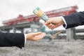 Hands of businessman passing Australian dollar (AUD) banknote. Royalty Free Stock Photo