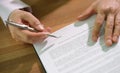 Hands of businessman with pen signing contract document at table closeup Royalty Free Stock Photo