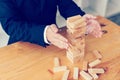Hands of businessman protect block wooden on table with risk concept