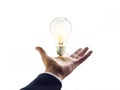 Hands of a businessman reaching to towards light bulb, business concept Royalty Free Stock Photo
