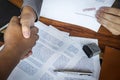 Hands of businessman shaking after to finish signing and stamp on paper document to approve business investment contract agreement Royalty Free Stock Photo