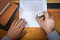 Hands of businessman stamp on paper document to approve business investment contract agreement Royalty Free Stock Photo