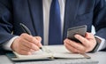 Hands of a businessman writing a schedule or recording ideas in a diary Royalty Free Stock Photo