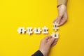 Hands of businessmen folded the word `Plan A B` from puzzles on a yellow background. Success strategy and alternative problem so