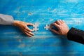 Hands of businesswoman and businessman holding matching puzzle pieces Royalty Free Stock Photo