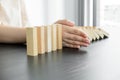 Hands of businesswoman stop block a wood game, gambling placing a wooden block. Concept Risk of management and strategy plan,