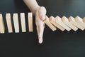 Hands of businesswoman stop block a wood game, gambling placing a wooden block. Concept Risk of management and strategy plan,