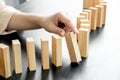 Hands of businesswomen playing wooden block game. Concept Risk of management and strategy plans for business growth and success