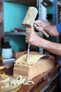 Hands of cabinetmaker carving wood with a chisel and hammer Royalty Free Stock Photo