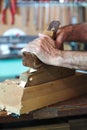 Hands of a cabinetmaker sanding