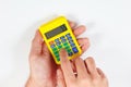 Hands calculate using a digital calculator on white background