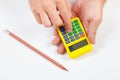 Hands calculate using a pocket calculator on white background