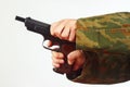 Hands in camouflage uniform reload gun on white background