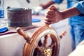 The hands of the captain and a steering wheel boat port services. Sea and travel concept Royalty Free Stock Photo