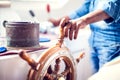 The hands of the captain and a steering wheel boat port services. Sea and travel concept Royalty Free Stock Photo