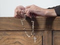 Hands of a Capuchin monk holding a rosary