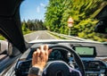 Hands of car driver on steering wheel, road trip, driving on highway road