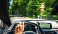 Hands of car driver on steering wheel, road trip, driving on highway road