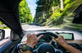 Hands of car driver on steering wheel, road trip, driving on highway road