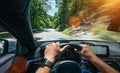 Hands of car driver on steering wheel, road trip, driving on highway road